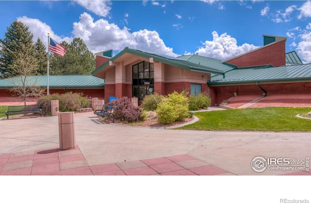 3445 Martin Dr, Boulder, CO 80305 - view of front of property featuring a standing seam roof, metal roof, brick siding, and a chimney