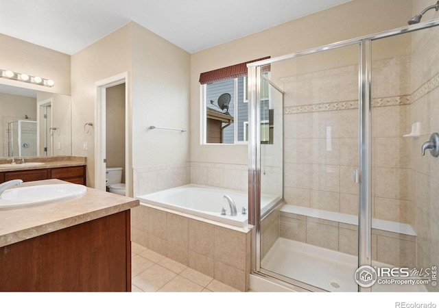 6340 Spring Valley Rd, Timnath, CO 80547 - bathroom featuring vanity, a shower stall, toilet, a bath, and tile patterned flooring
