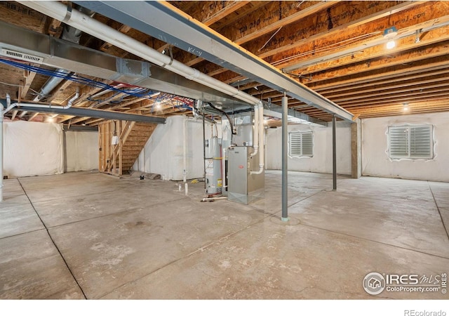 6340 Spring Valley Rd, Timnath, CO 80547 - unfinished basement featuring stairs, heating unit, and gas water heater