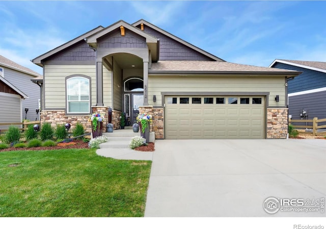 5512 Bristow Rd, Timnath, CO 80547 - craftsman-style house featuring stone siding, driveway, a garage, and a front lawn