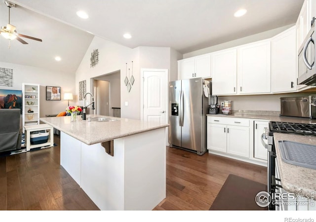 5512 Bristow Rd, Timnath, CO 80547 - kitchen with stainless steel appliances, a sink, dark wood-style floors, white cabinets, and vaulted ceiling