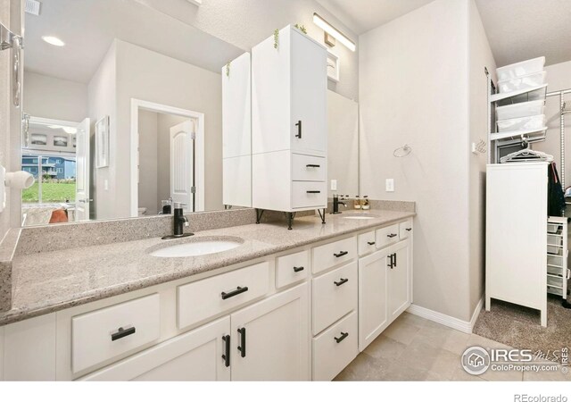 5512 Bristow Rd, Timnath, CO 80547 - bathroom with double vanity, baseboards, toilet, and a walk in closet