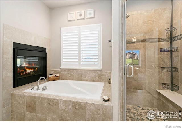 5512 Bristow Rd, Timnath, CO 80547 - full bath featuring a garden tub, a shower stall, and a tile fireplace