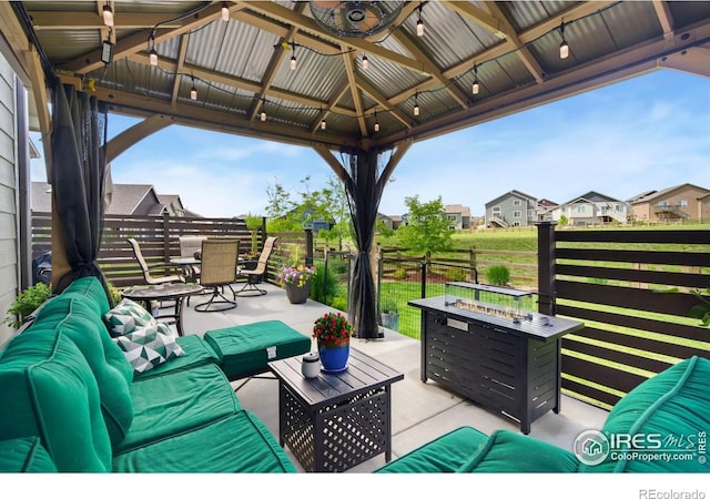 5512 Bristow Rd, Timnath, CO 80547 - view of patio featuring an outdoor living space with a fire pit, outdoor dining space, a gazebo, and a residential view