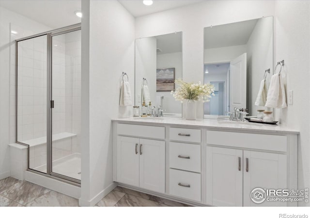 645 Flintwood Pl, Lafayette, CO 80026 - full bathroom with marble finish flooring, a stall shower, double vanity, baseboards, and recessed lighting
