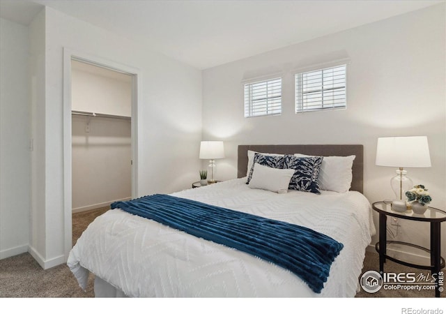 645 Flintwood Pl, Lafayette, CO 80026 - bedroom featuring carpet floors, baseboards, a walk in closet, and a closet