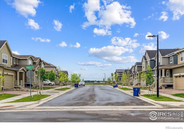 645 Flintwood Pl, Lafayette, CO 80026 - view of asphalt road with a residential view, sidewalks, street lights, and curbs
