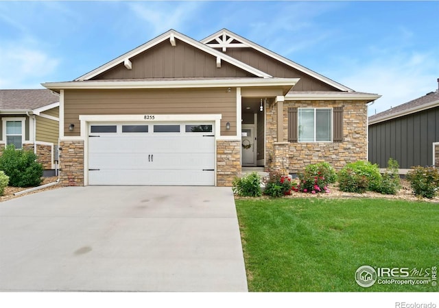 8255 Eagle Dr, Greeley, CO 80634 - craftsman inspired home featuring stone siding, board and batten siding, a front lawn, concrete driveway, and an attached garage