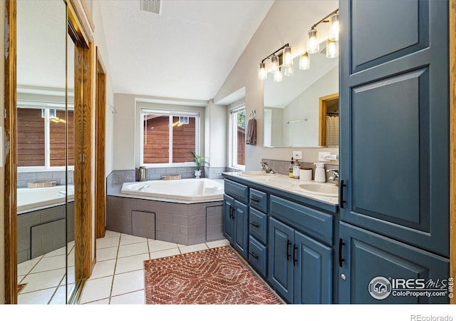 1954 Bluestem Way, Fairplay, CO 80440 - full bathroom with double vanity, a garden tub, tile patterned floors, and vaulted ceiling