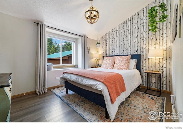 1954 Bluestem Way, Fairplay, CO 80440 - bedroom featuring baseboards, wood finished floors, and a chandelier