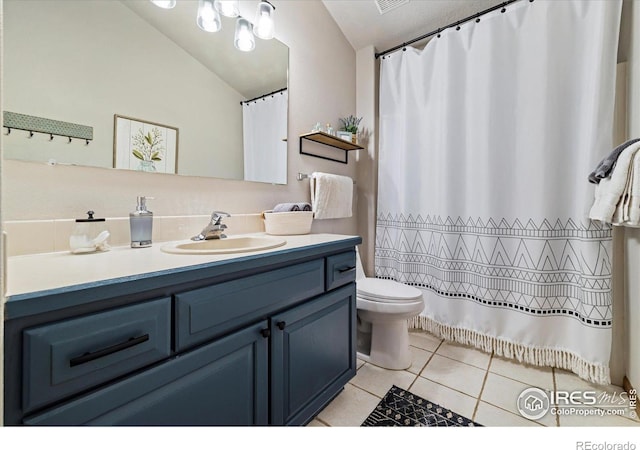 1954 Bluestem Way, Fairplay, CO 80440 - bathroom with vanity, tile patterned flooring, toilet, and lofted ceiling