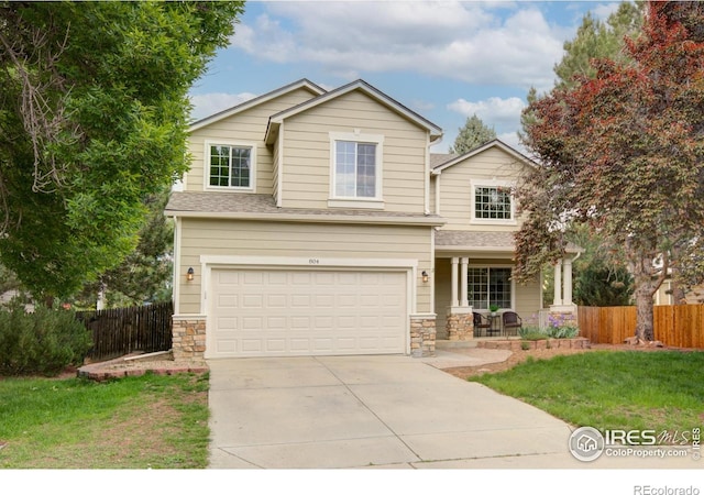 804 Nelson Park Ln, Longmont, CO 80503 - view of front of house featuring covered porch, driveway, a garage, and roof with shingles