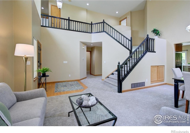 804 Nelson Park Ln, Longmont, CO 80503 - carpeted living area with a high ceiling, stairs, baseboards, and recessed lighting