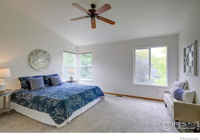 804 Nelson Park Ln, Longmont, CO 80503 - carpeted bedroom featuring multiple windows, vaulted ceiling, baseboards, and a ceiling fan