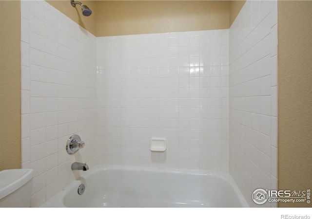 804 Nelson Park Ln, Longmont, CO 80503 - full bathroom with toilet, tub / shower combination, and a textured wall
