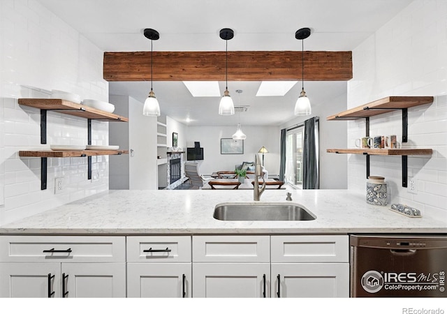 3255 34th St Unit 42, Boulder, CO 80301 - kitchen featuring open shelves, stainless steel dishwasher, a sink, a skylight, and beam ceiling