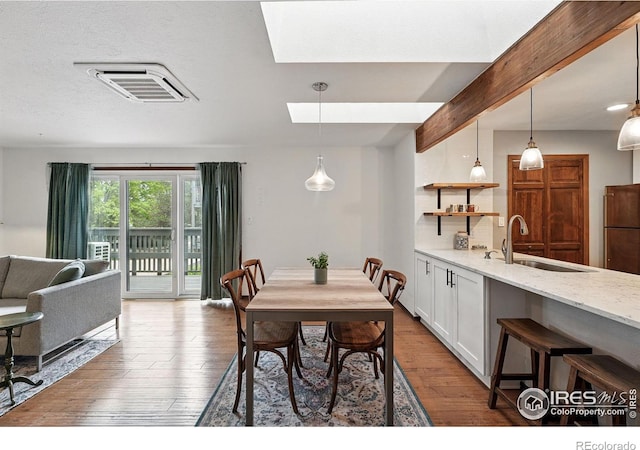 3255 34th St Unit 42, Boulder, CO 80301 - dining area featuring wood finished floors and a skylight