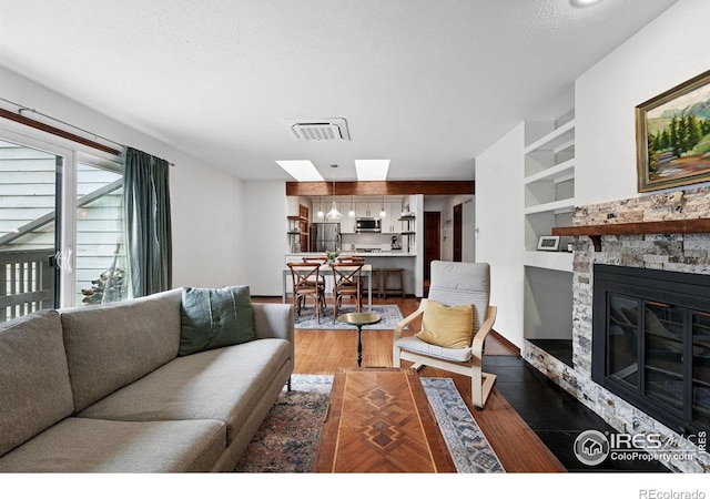 3255 34th St Unit 42, Boulder, CO 80301 - living room with a skylight, wood finished floors, a fireplace, and built in features