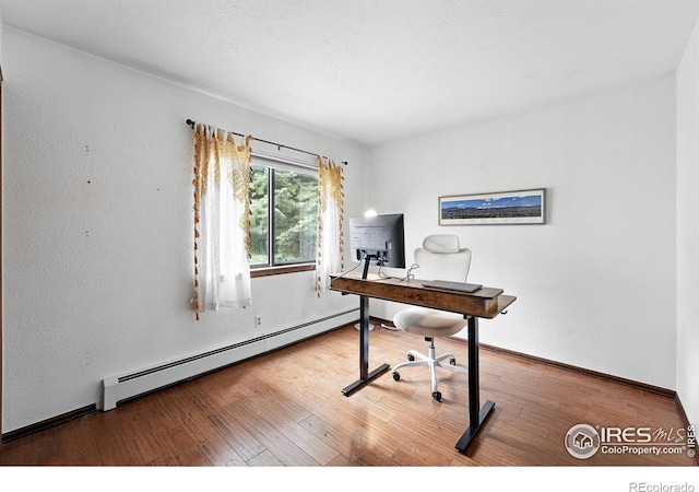 3255 34th St Unit 42, Boulder, CO 80301 - office area with a baseboard heating unit, wood finished floors, and baseboards