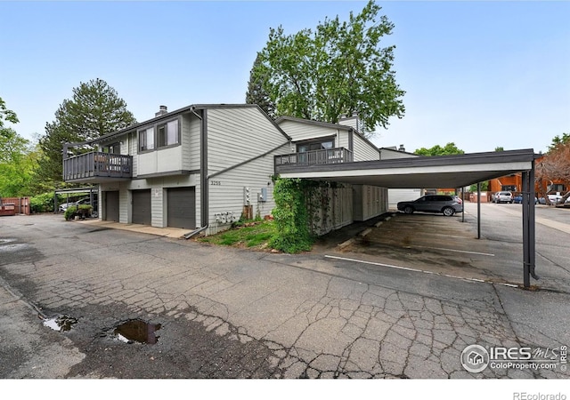 3255 34th St Unit 42, Boulder, CO 80301 - view of property exterior featuring a chimney, a balcony, and covered parking