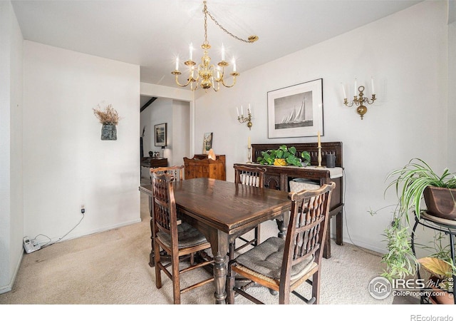 1702 Kennedy Ave, Loveland, CO 80538 - dining space with light colored carpet, a chandelier, and baseboards