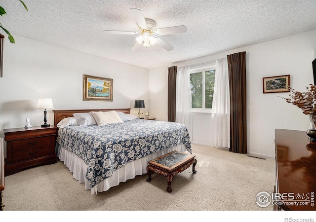 1702 Kennedy Ave, Loveland, CO 80538 - bedroom with light colored carpet, a textured ceiling, and a ceiling fan