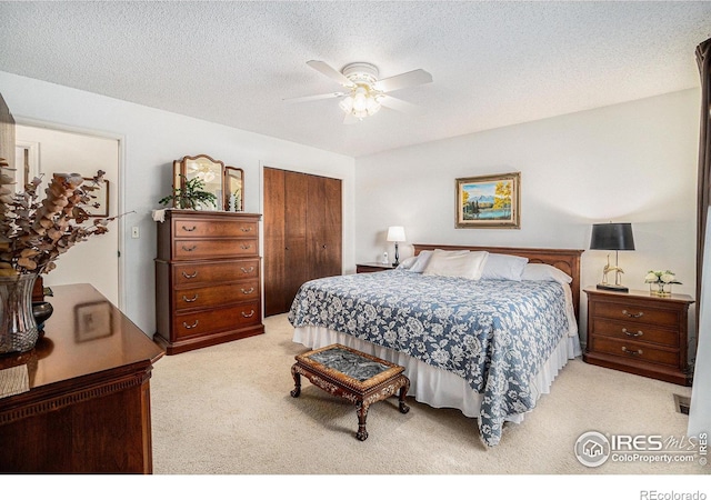 1702 Kennedy Ave, Loveland, CO 80538 - bedroom with carpet flooring, a closet, a ceiling fan, and a textured ceiling