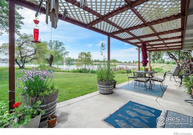 1702 Kennedy Ave, Loveland, CO 80538 - view of patio / terrace with a water view, outdoor dining area, and a pergola