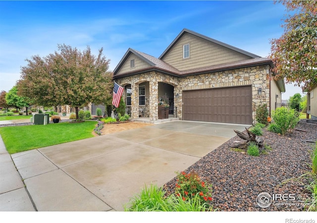 2038 Vineyard Dr, Windsor, CO 80550 - view of front of house with stone siding, an attached garage, driveway, a front yard, and a porch