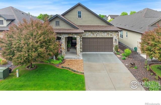 2038 Vineyard Dr, Windsor, CO 80550 - view of front facade featuring stone siding, an attached garage, driveway, and a front yard