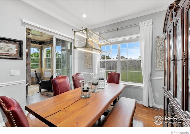 2038 Vineyard Dr, Windsor, CO 80550 - dining room with hardwood / wood-style floors, crown molding, healthy amount of natural light, and baseboards