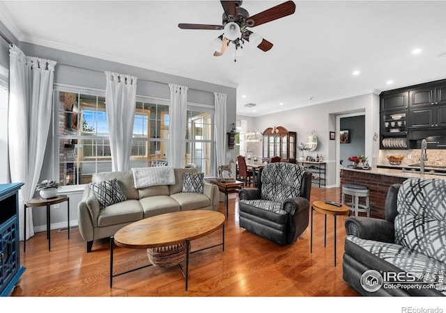 2038 Vineyard Dr, Windsor, CO 80550 - living area with light wood-style flooring, a ceiling fan, ornamental molding, recessed lighting, and baseboards