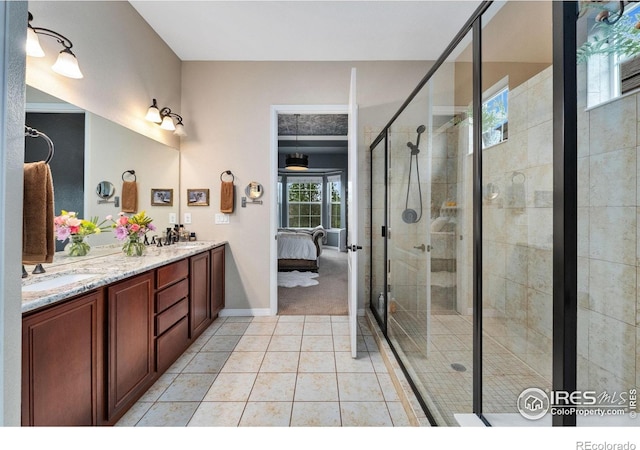 2038 Vineyard Dr, Windsor, CO 80550 - bathroom featuring double vanity, a stall shower, ensuite bathroom, tile patterned flooring, and baseboards