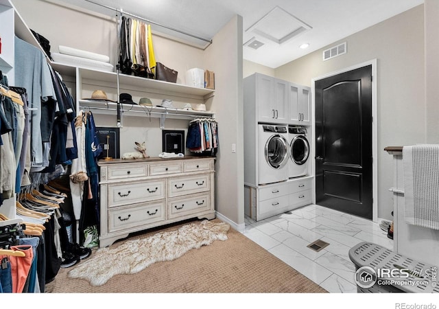 2038 Vineyard Dr, Windsor, CO 80550 - laundry room featuring attic access, separate washer and dryer, cabinet space, baseboards, and light marble finish flooring