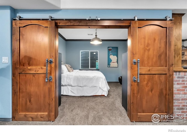 2038 Vineyard Dr, Windsor, CO 80550 - carpeted bedroom with ornamental molding and a barn door