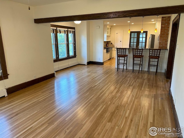 515 Cowan St, Fort Collins, CO 80524 - unfurnished living room featuring baseboards, light wood-style flooring, and recessed lighting