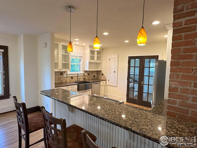 515 Cowan St, Fort Collins, CO 80524 - kitchen with a sink, stainless steel appliances, wood finished floors, glass insert cabinets, and baseboards