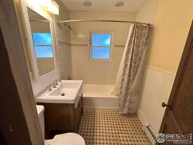 515 Cowan St, Fort Collins, CO 80524 - full bathroom featuring baseboard heating, toilet, tile patterned floors, shower / bath combo with shower curtain, and vanity