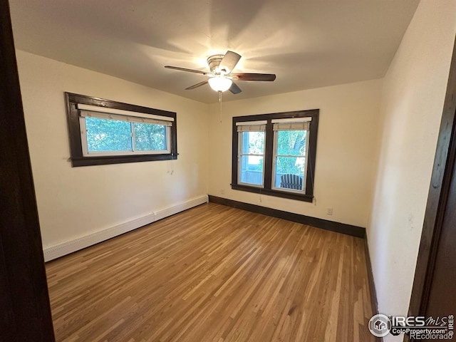 515 Cowan St, Fort Collins, CO 80524 - unfurnished room featuring baseboards, wood finished floors, a baseboard heating unit, and ceiling fan