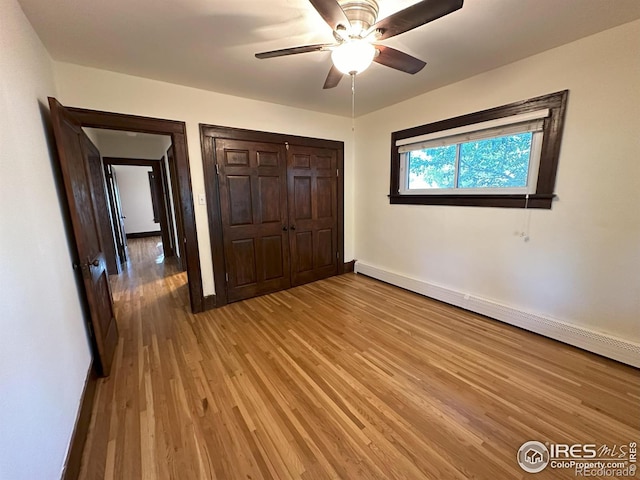 515 Cowan St, Fort Collins, CO 80524 - unfurnished bedroom with a baseboard heating unit, light wood-type flooring, baseboards, a closet, and ceiling fan