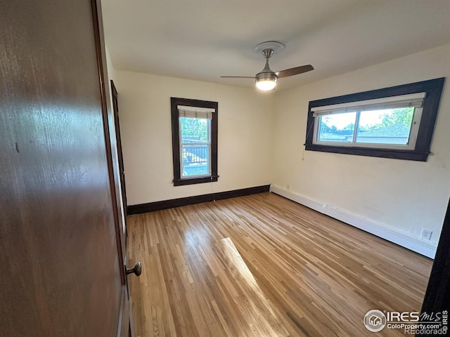 515 Cowan St, Fort Collins, CO 80524 - spare room featuring healthy amount of natural light, baseboards, light wood-style floors, and a baseboard radiator