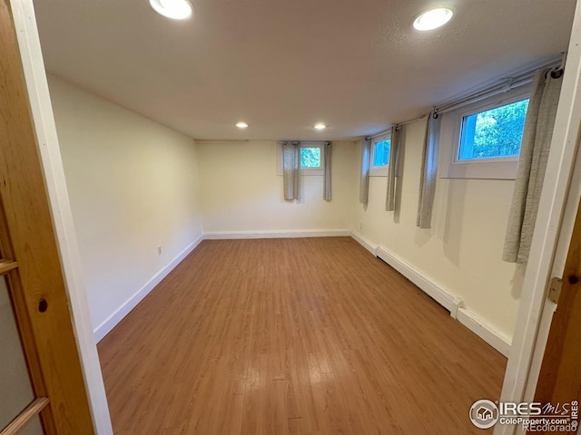 515 Cowan St, Fort Collins, CO 80524 - basement featuring a baseboard radiator, wood finished floors, recessed lighting, and baseboards