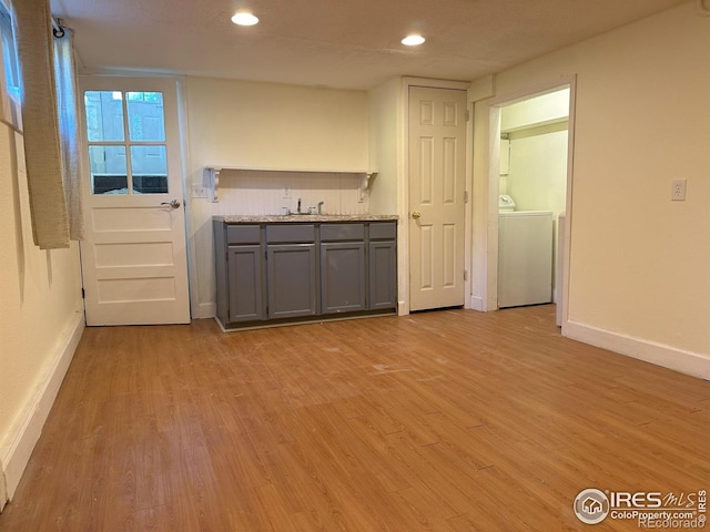515 Cowan St, Fort Collins, CO 80524 - kitchen with washer / dryer, gray cabinets, light wood-style flooring, baseboards, and recessed lighting
