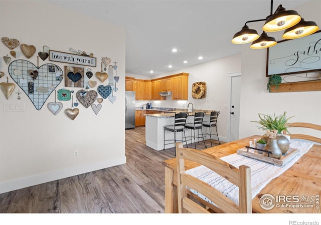 36091 Appy Rd, Eaton, CO 80615 - dining space featuring recessed lighting, wood finished floors, and baseboards
