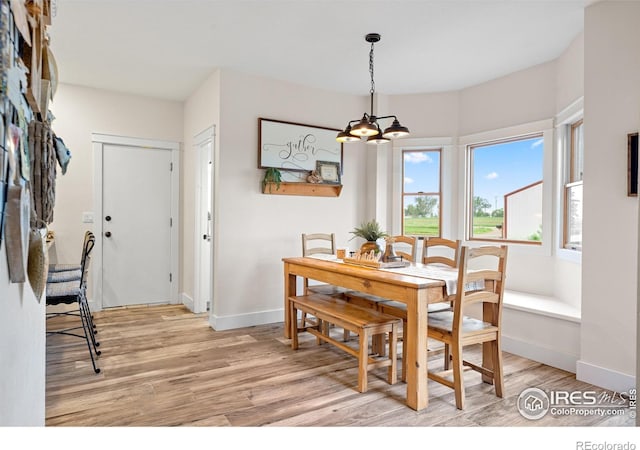 36091 Appy Rd, Eaton, CO 80615 - dining room with light wood-style floors, a chandelier, and baseboards