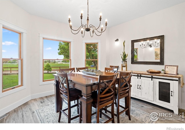 36091 Appy Rd, Eaton, CO 80615 - dining room featuring a chandelier, light wood-style flooring, and baseboards