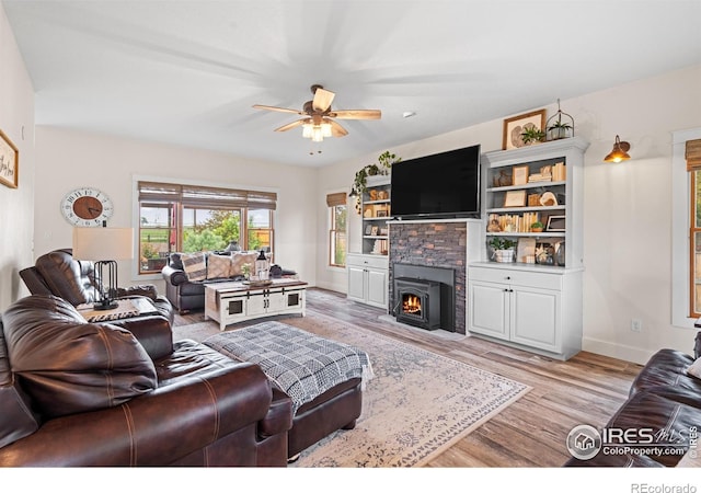 36091 Appy Rd, Eaton, CO 80615 - living area featuring ceiling fan, light wood finished floors, a fireplace, and baseboards