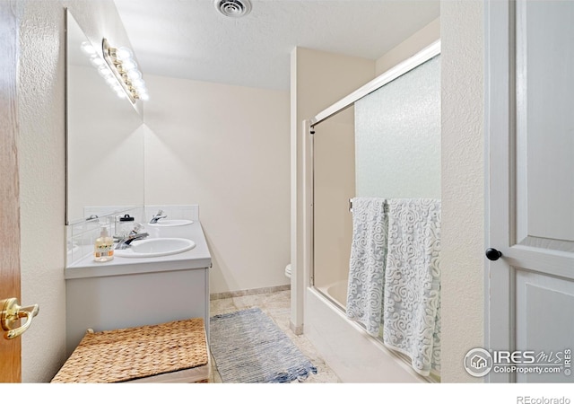 36091 Appy Rd, Eaton, CO 80615 - full bathroom featuring double vanity, toilet, enclosed tub / shower combo, and tile patterned floors