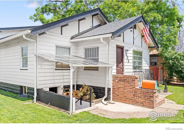 1805 8th St, Greeley, CO 80631 - rear view of house featuring a lawn and a shingled roof