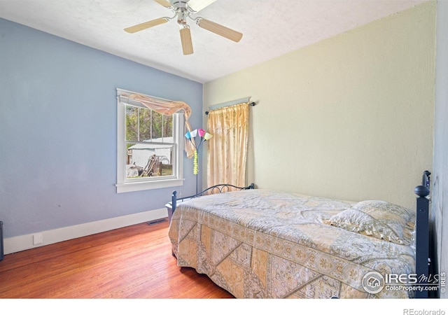 1805 8th St, Greeley, CO 80631 - bedroom with wood finished floors, baseboards, and ceiling fan
